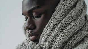 裹着针织围巾的沉思黑人