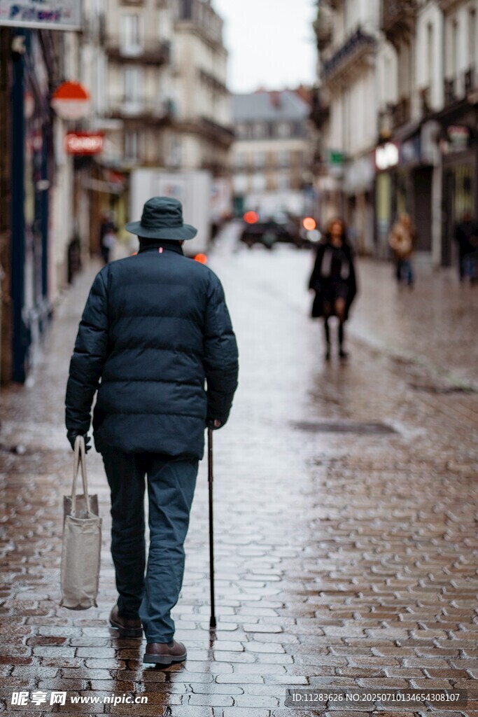 雨中独行的拄拐老人