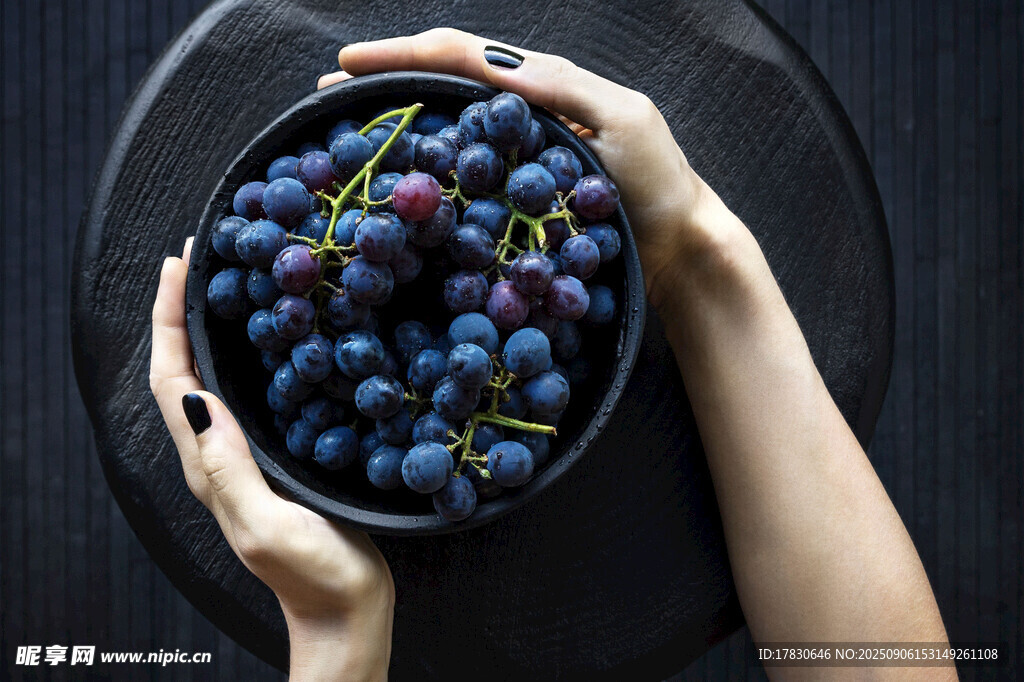 双手捧起的新鲜紫葡萄