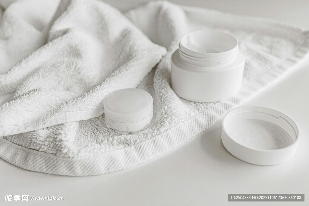 白色护肤用品与柔软毛巾