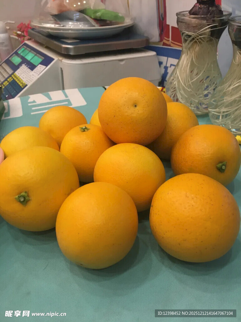 一堆新鲜橙子摆放在桌前