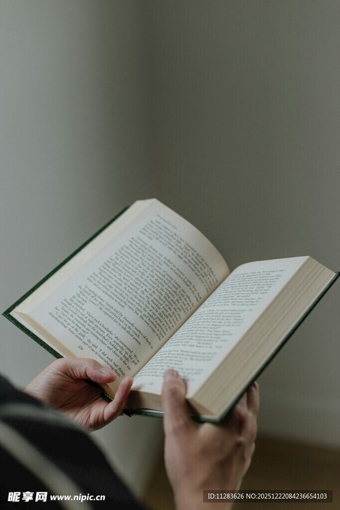 双手捧读翻开的书籍