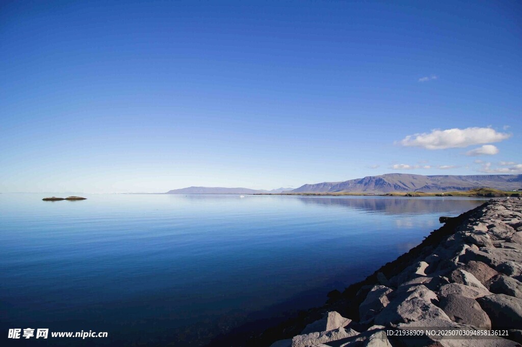 宁静湖畔的石岸与蓝天