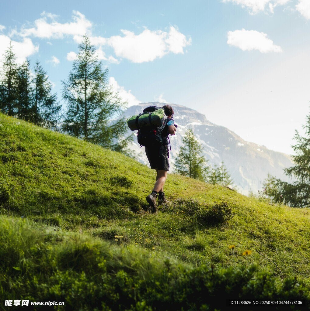徒步者在山间草地前行