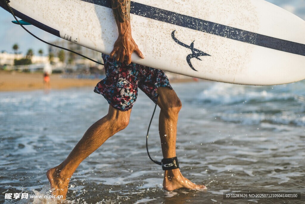 冲浪者踏浪携板前行