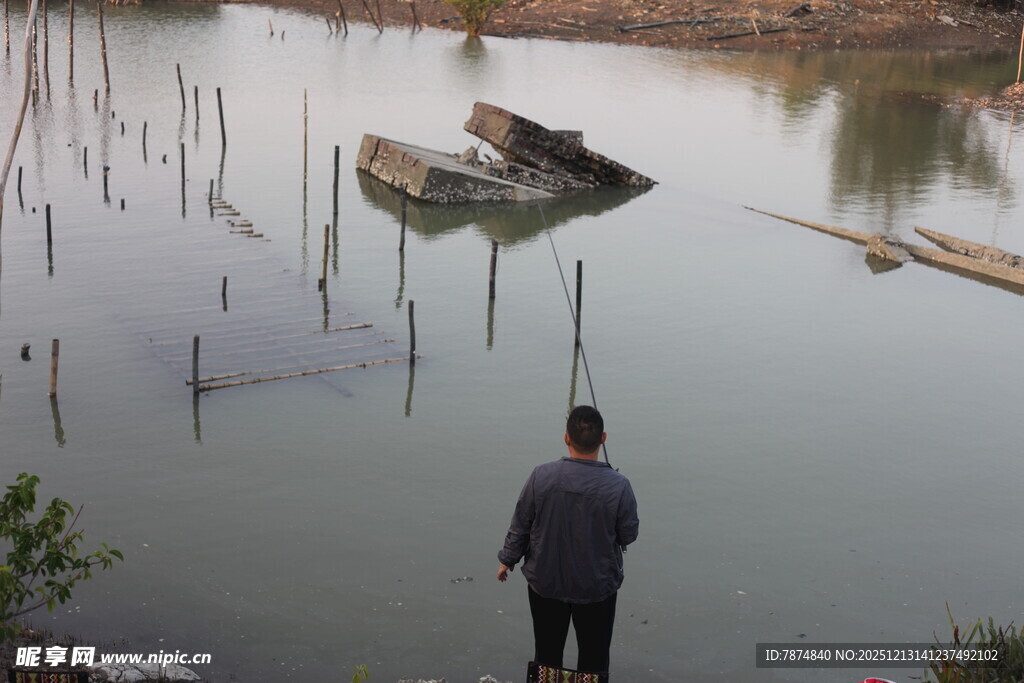 男子岸边望水中漂浮船只