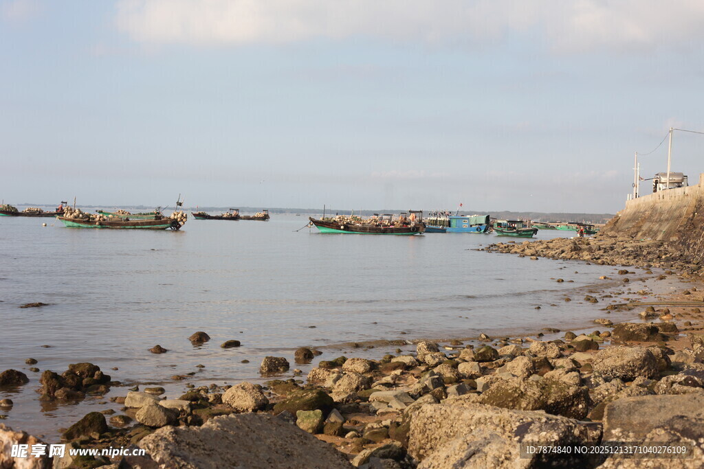 海边礁石旁停泊的多彩船只