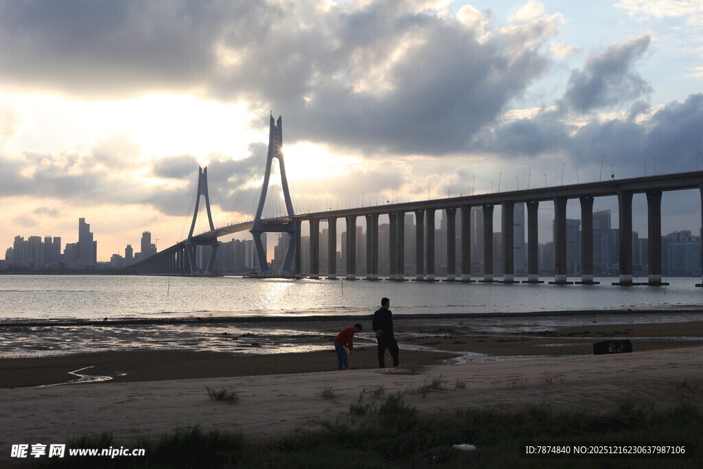 夕阳下的大桥与岸边行人