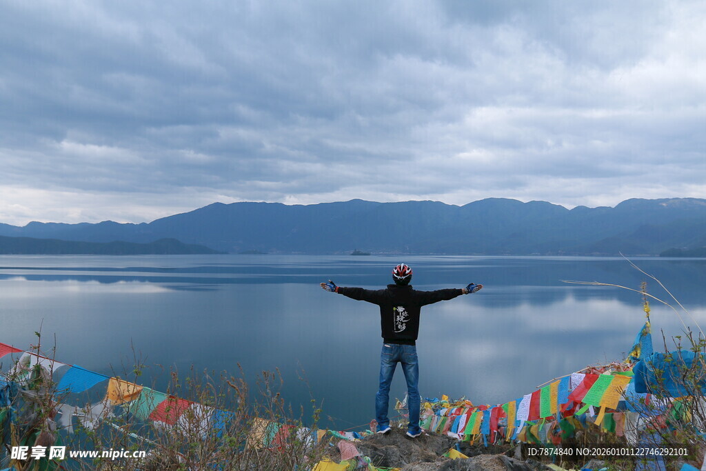 湖畔旅人张开双臂赏美景