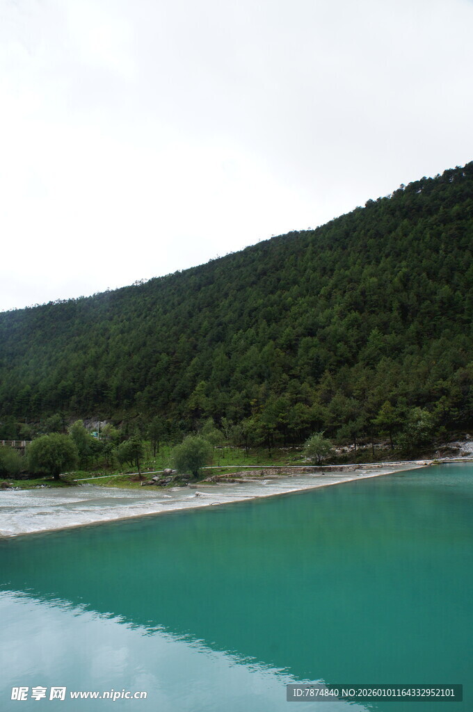 翠绿山峦旁的澄澈蓝湖