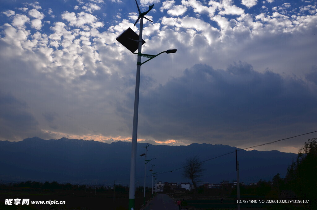 路灯矗立在多云天空下