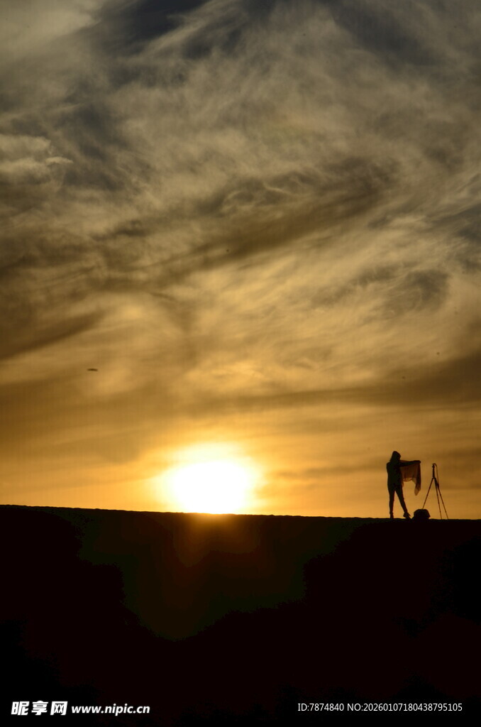 夕阳下的沙漠徒步身影