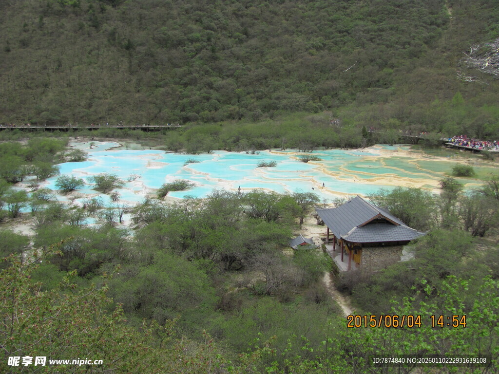 山间彩池旁的古朴小屋