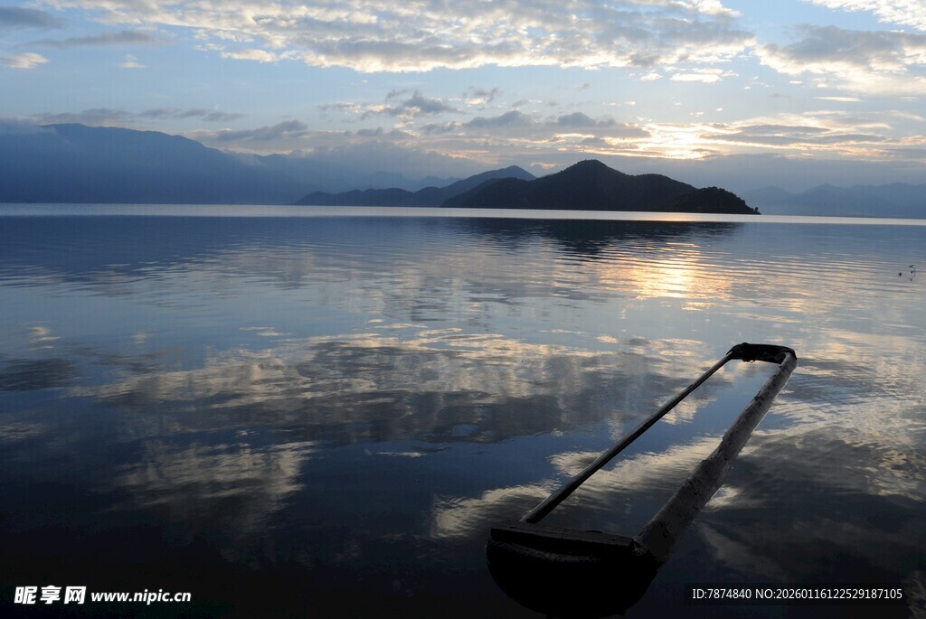 湖畔日出美景中的长杆倒影