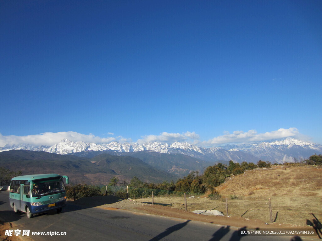 公路旁的雪山与行驶车辆