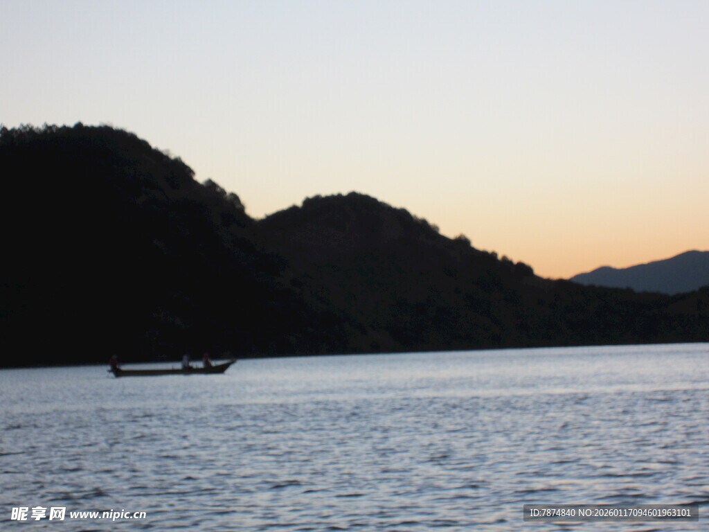 黄昏湖面小船与远山景色