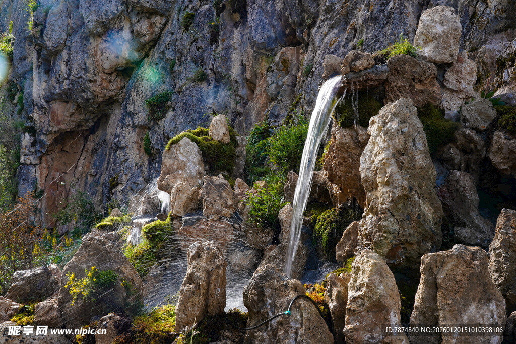 山间瀑布垂落于嶙峋怪石