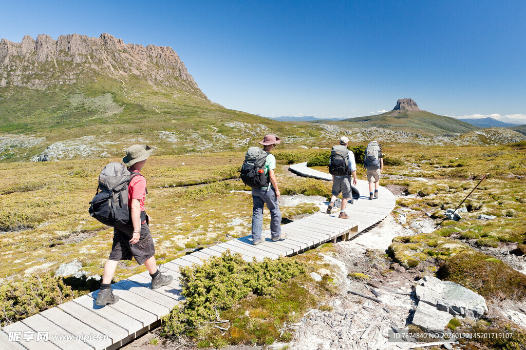 徒步者漫步于山间木板路