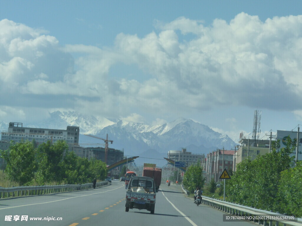 公路上驶向雪山的车辆