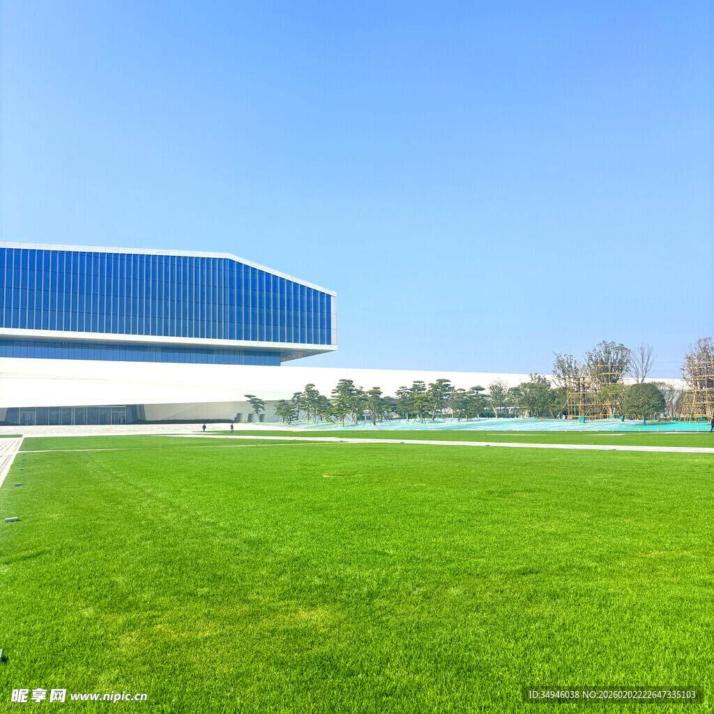 蓝白建筑旁的翠绿草坪