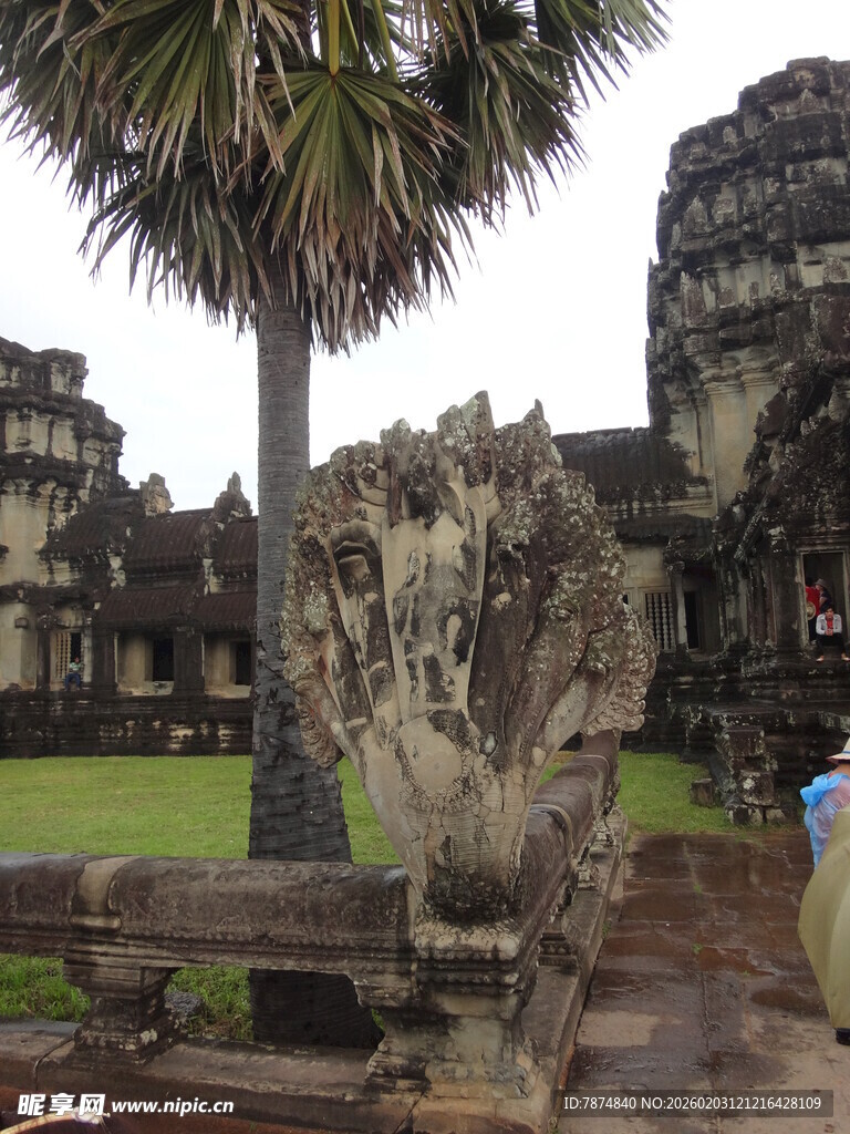 古老寺庙旁的石雕与棕榈树