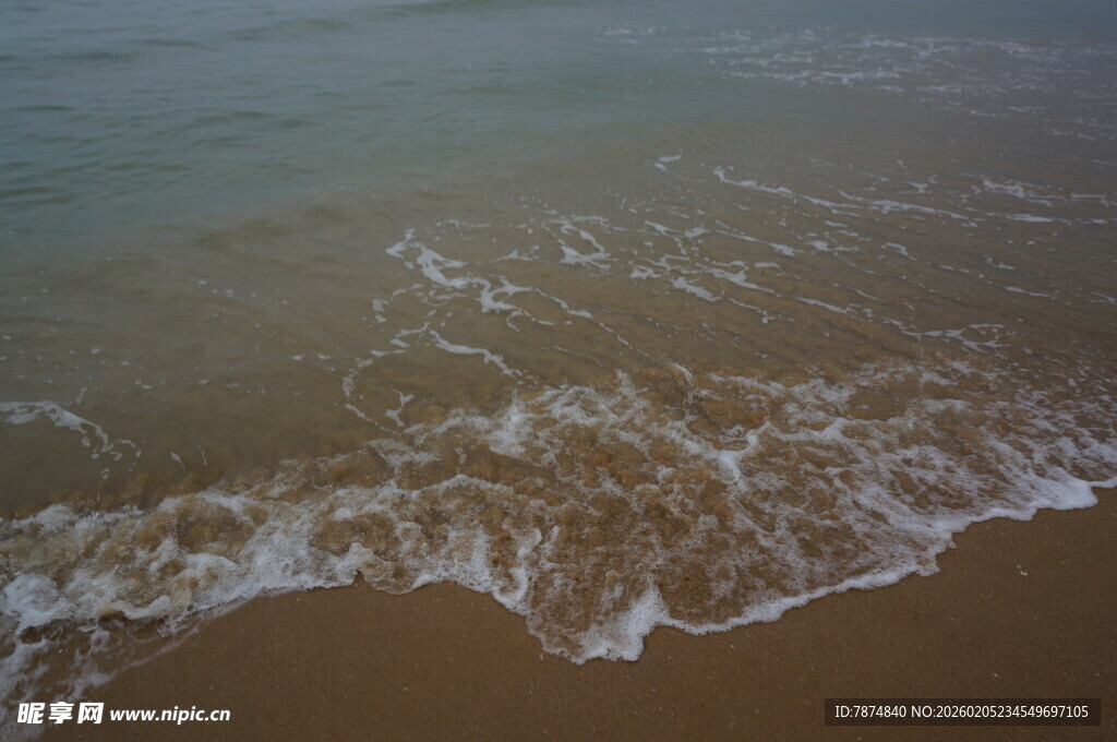 三亚海浪轻拍沙滩的美丽瞬间