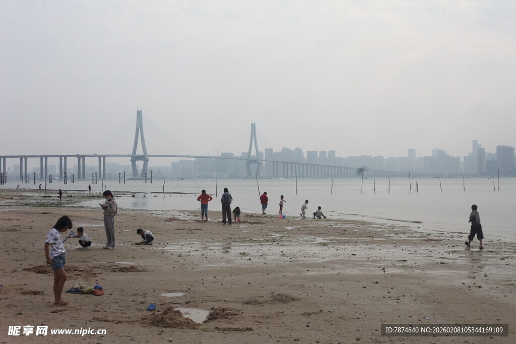 湛江江边沙滩上的休闲人群