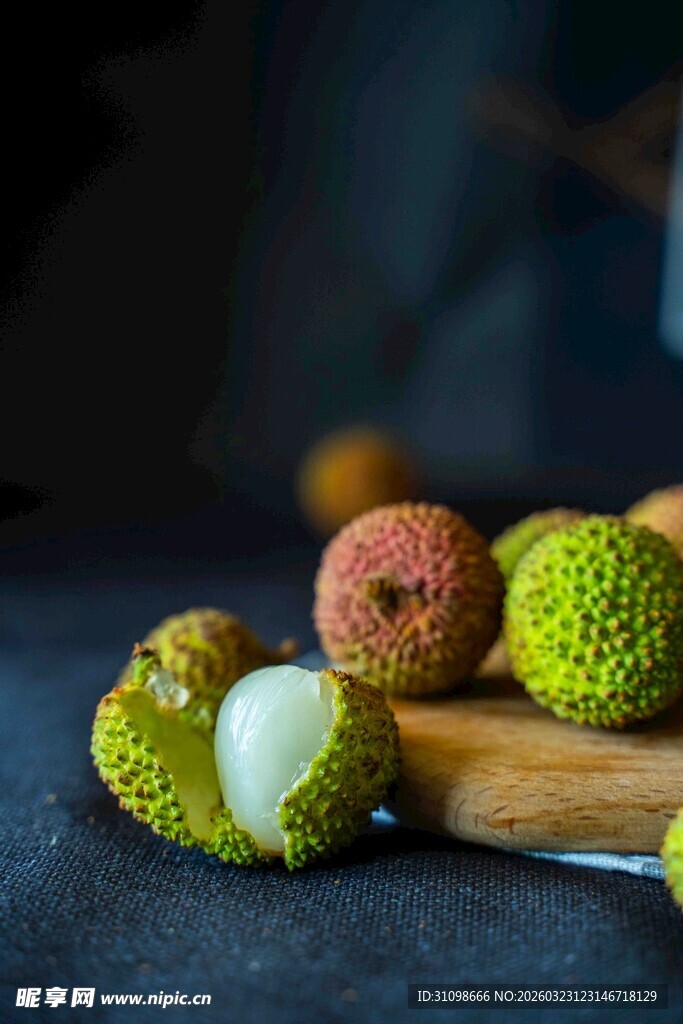 新鲜荔枝摆放在木砧板上