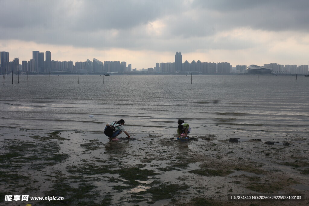 湛江城市边滩涂漫步的两人
