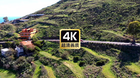 航拍山间公路上行驶的汽车