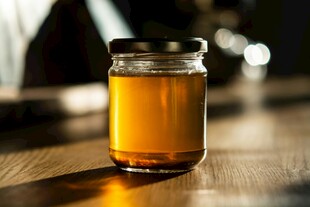 木桌上的蜂蜜玻璃罐