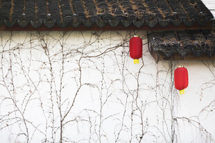 红灯笼挂于斑驳墙面