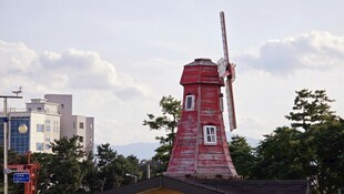 红色风车矗立城市间