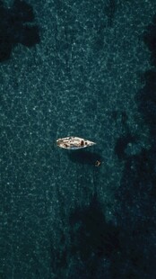 海上孤舟漂浮于深蓝海域