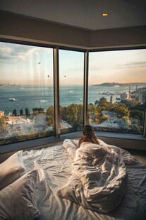 窗边卧床赏海景惬意瞬间