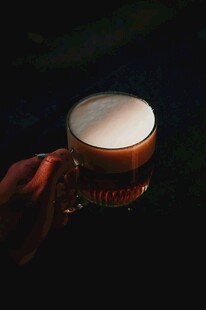 手持泡沫丰富的啤酒杯