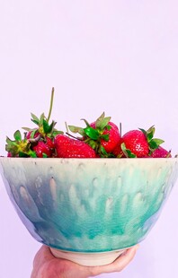 手捧蓝碗盛新鲜红草莓