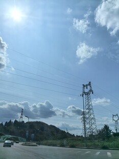 公路边的输电塔与蓝天