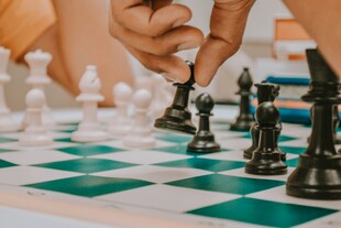 手挪棋子于棋盘博弈时刻