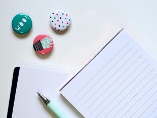 多彩文具摆放在空白笔记本旁