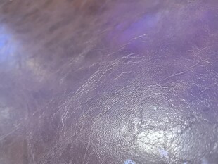 梦幻紫色灯光下的皮革纹理背景