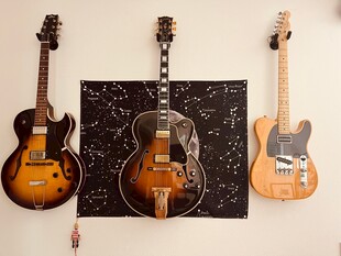 三把精美吉他靠墙展示