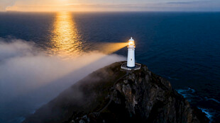 悬崖灯塔映夕阳美景