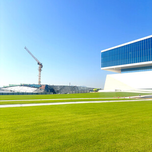 现代建筑旁的开阔绿草地