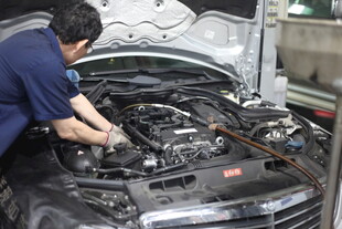 汽修工人专注检修汽车引擎