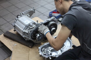 工人专注维修汽车变速箱