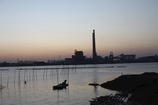 黄昏江畔工厂与小船景象