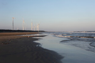 海边黄昏下的风力发电机组