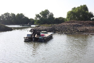 河边小船旁的劳作场景