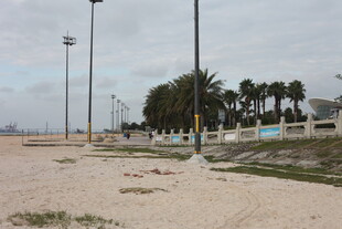 空旷沙滩与远处林立灯杆